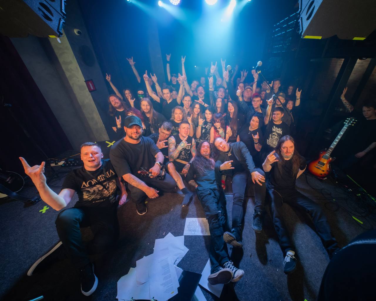 Concert crowd with blue stage lighting